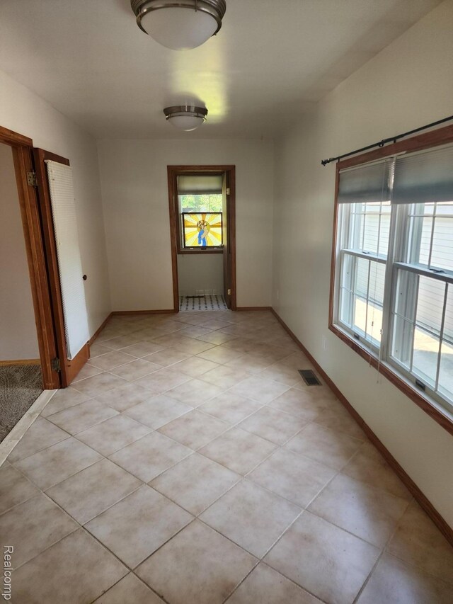 5140 Eastview Rd, Clarkston, MI 48346 - unfurnished room with healthy amount of natural light and light tile patterned floors