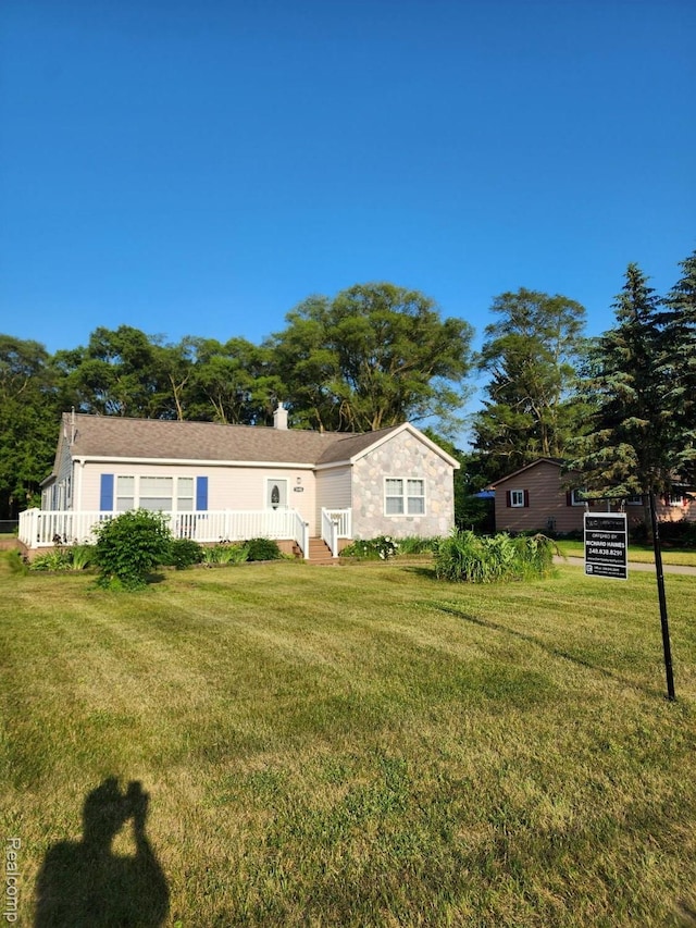 5140 Eastview Rd, Clarkston, MI 48346 - view of front of house featuring a front lawn and a chimney