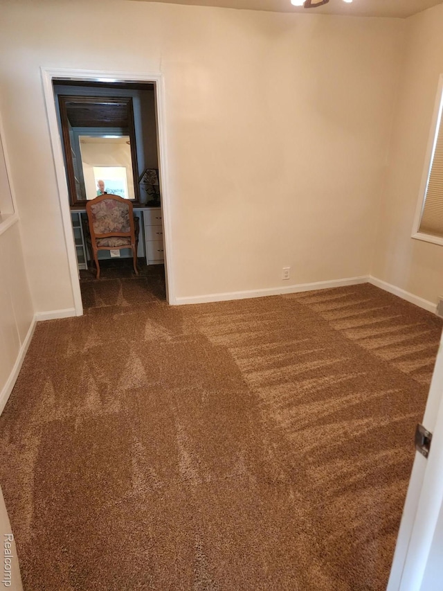 5140 Eastview Rd, Clarkston, MI 48346 - empty room with dark colored carpet and baseboards