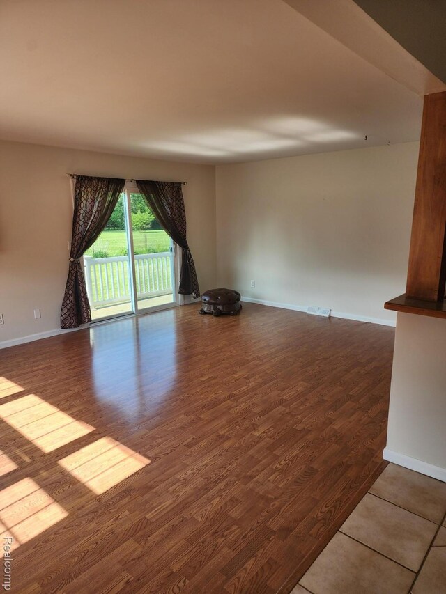 5140 Eastview Rd, Clarkston, MI 48346 - empty room with wood finished floors and baseboards