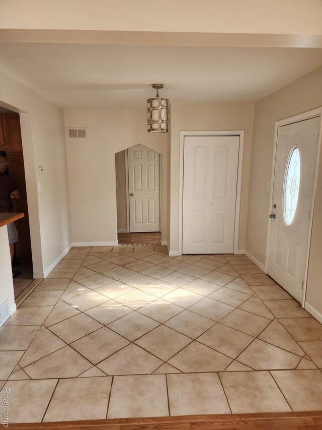 5140 Eastview Rd, Clarkston, MI 48346 - foyer with light tile patterned floors and baseboards