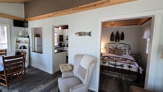 bedroom featuring wooden ceiling, freestanding refrigerator, dark wood-style floors, and vaulted ceiling