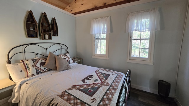 bedroom featuring lofted ceiling, baseboards, wood finished floors, and wood ceiling