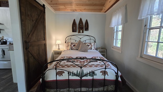 bedroom featuring a barn door, wood finished floors, and wood ceiling