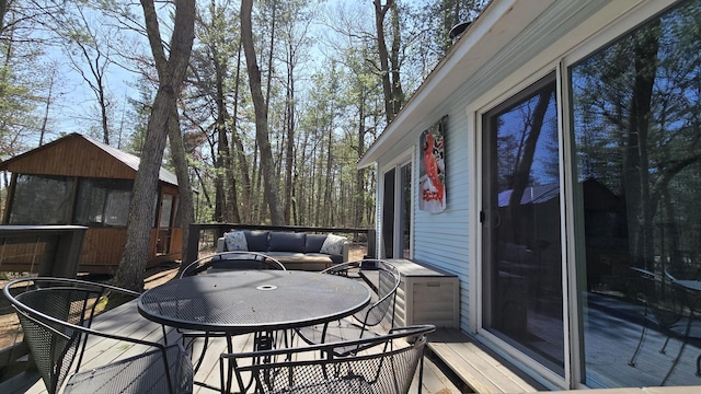 wooden terrace featuring outdoor dining area