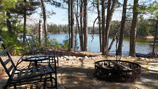 view of patio featuring a fire pit and a water view