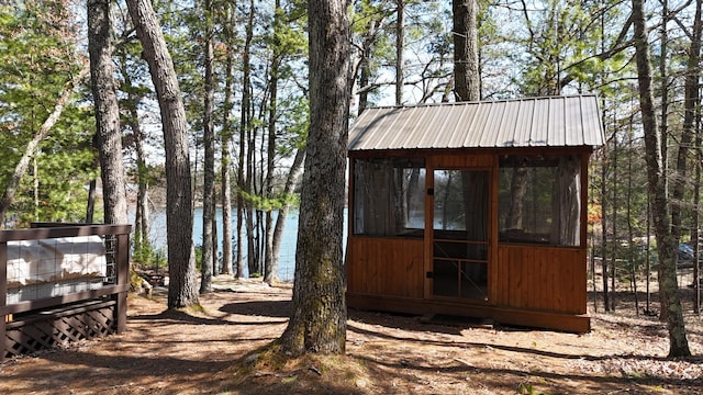 view of outdoor structure featuring an outbuilding and a water view