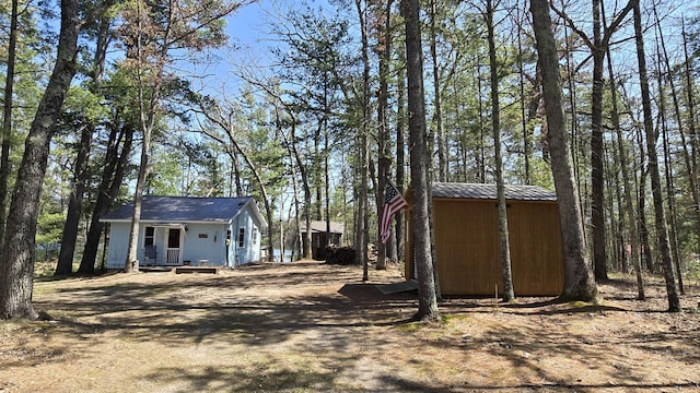 view of side of home with an outdoor structure and metal roof