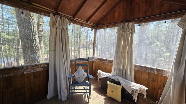 sunroom with wood-type flooring, lofted ceiling, wood walls, and wood ceiling