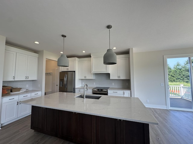 6669 Yamoto Way Lot 7, Douglas, MI 49406 - kitchen with stainless steel appliances, wood finished floors, backsplash, a large island, and recessed lighting