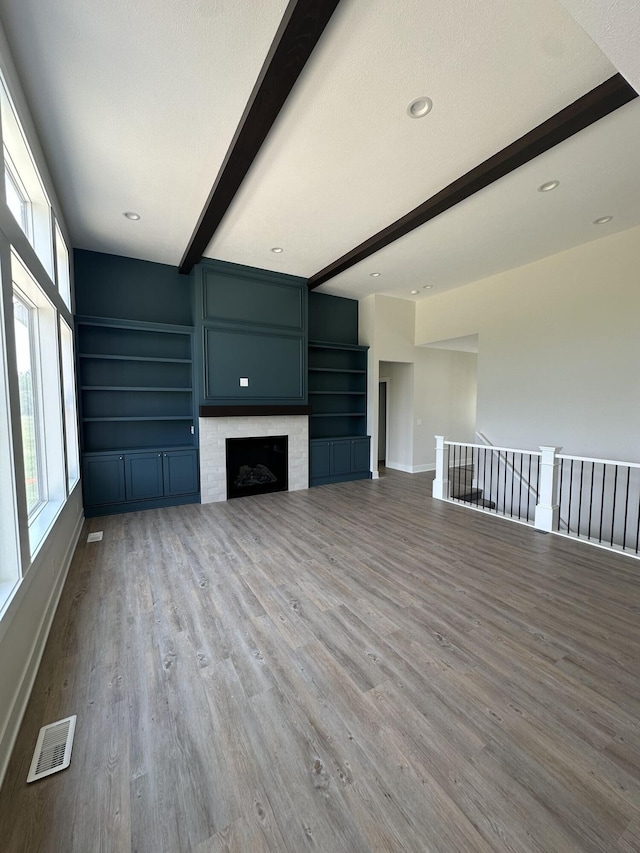 6669 Yamoto Way Lot 7, Douglas, MI 49406 - unfurnished living room with beamed ceiling, wood finished floors, and a fireplace