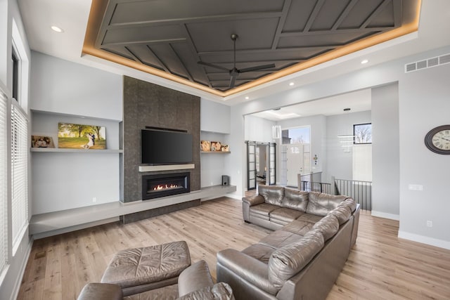 73404 Castle, Armada, MI 48005 - living area with coffered ceiling, light wood-style flooring, baseboards, a fireplace, and recessed lighting