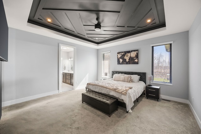 bedroom featuring light colored carpet, multiple windows, and a raised ceiling