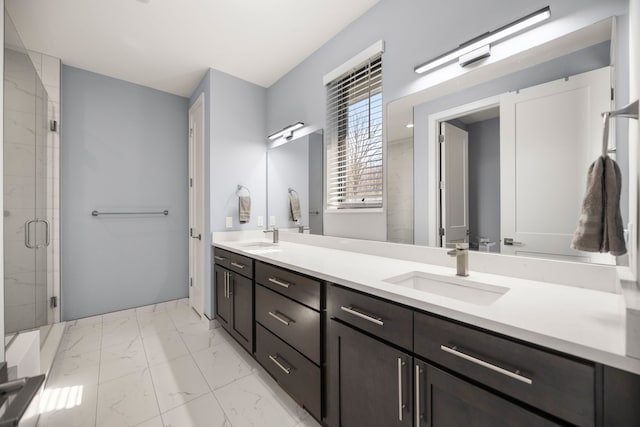 full bath with a shower stall, marble finish floor, a sink, and double vanity