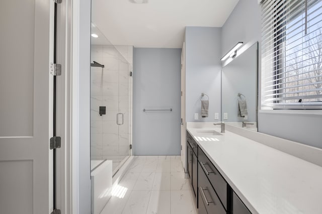 bathroom with a stall shower, marble finish floor, vanity, and a healthy amount of sunlight