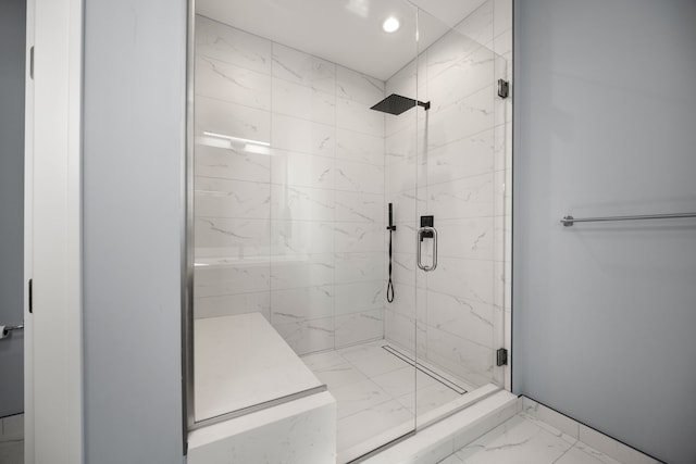 full bath with marble finish floor and a stall shower