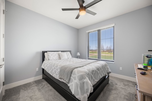 carpeted bedroom with ceiling fan and baseboards