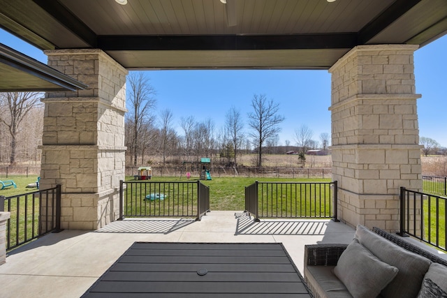 view of patio / terrace featuring fence and a playground