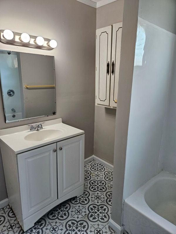22419 Hoffman St, Saint Clair Shores, MI 48082 - bathroom with a tub, baseboards, tile patterned floors, and vanity