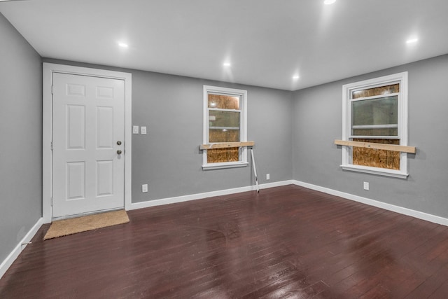 interior space with baseboards, dark wood-style floors, and recessed lighting