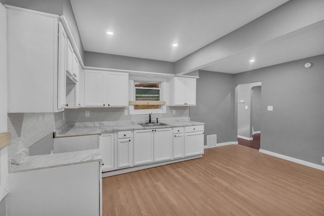 kitchen featuring recessed lighting, baseboards, tasteful backsplash, and light wood-style flooring