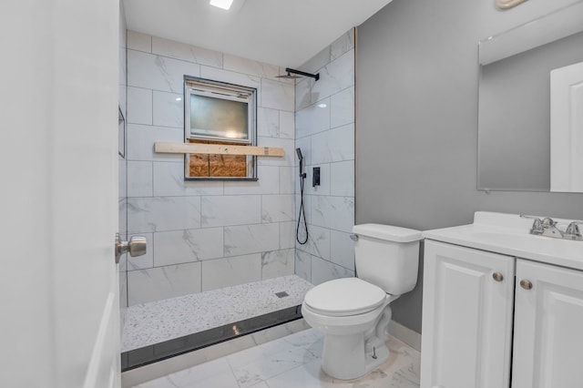 full bathroom with a tile shower, marble finish floor, vanity, and toilet