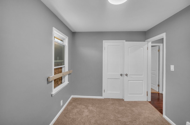interior space with baseboards, carpet, and a closet