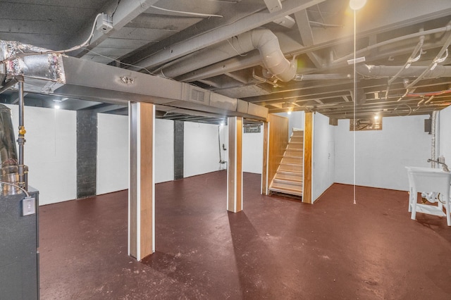 basement featuring a sink and stairway