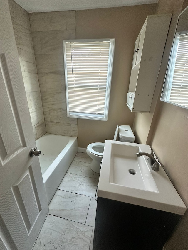 15913 Petoskey Ave, Detroit, MI 48238 - full bathroom with vanity, toilet, marble finish floor, a washtub, and baseboards