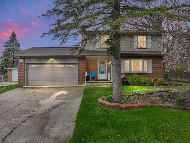 826 Hendricks Dr, Monroe, MI 48162 - traditional-style house featuring an attached garage, a lawn, driveway, and brick siding
