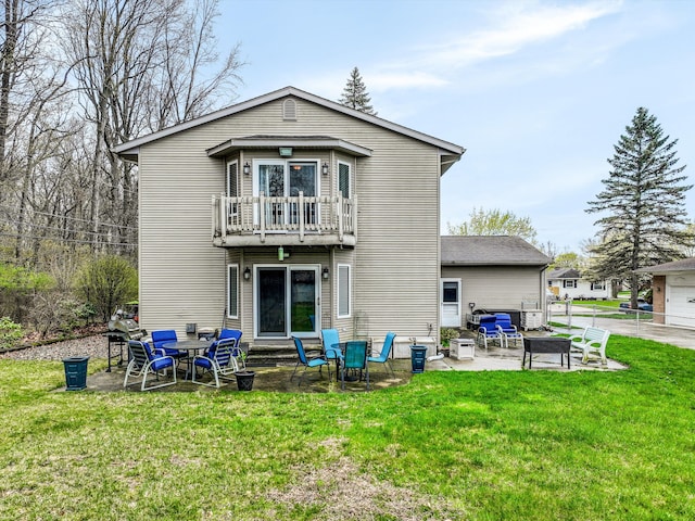 826 Hendricks Dr, Monroe, MI 48162 - back of property with a fire pit, a patio, a yard, and a balcony
