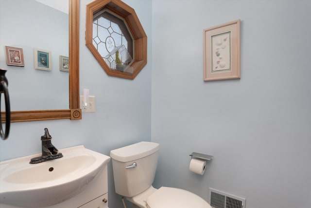 826 Hendricks Dr, Monroe, MI 48162 - bathroom featuring visible vents, vanity, and toilet