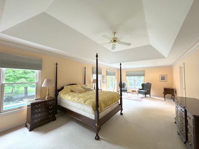 bedroom with a ceiling fan, crown molding, a raised ceiling, light colored carpet, and baseboards
