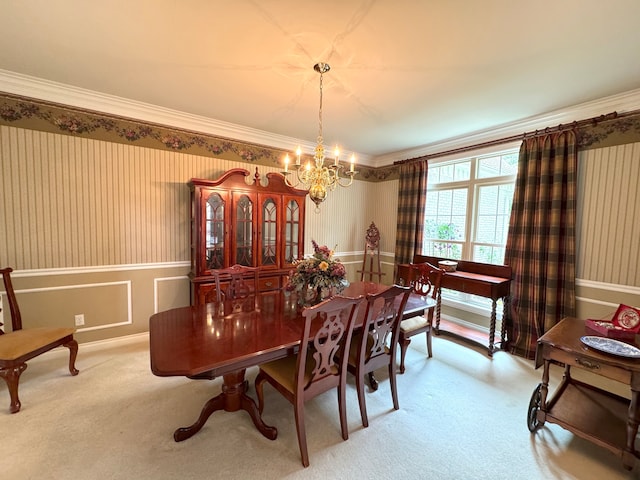 carpeted dining area with wainscoting, an inviting chandelier, ornamental molding, and wallpapered walls