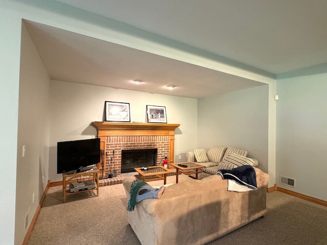 living area with a fireplace, carpet floors, visible vents, and baseboards