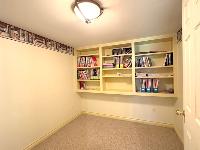 spare room with carpet and baseboards