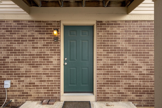 property entrance with brick siding