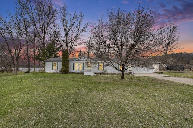 view of front of home featuring a lawn and driveway