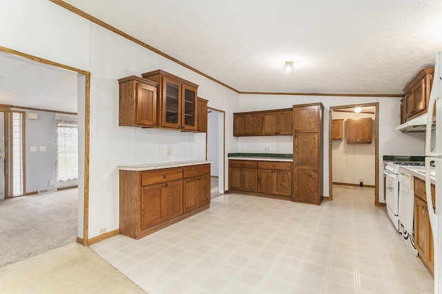kitchen featuring brown cabinetry, crown molding, white gas range, and light countertops
