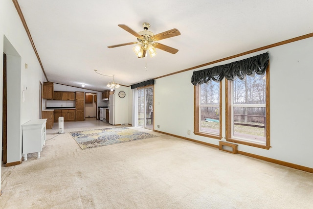 unfurnished living room featuring crown molding, ceiling fan with notable chandelier, light colored carpet, baseboards, and lofted ceiling