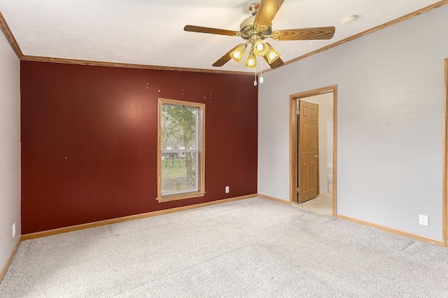 spare room featuring baseboards, ceiling fan, light colored carpet, and ornamental molding