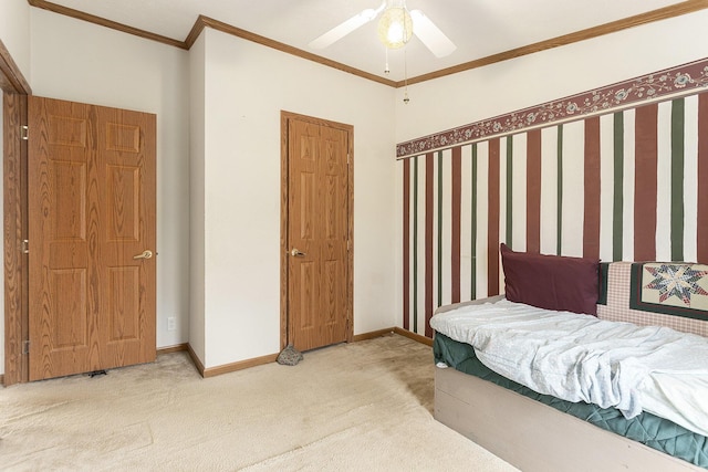 bedroom with carpet, a ceiling fan, baseboards, and ornamental molding
