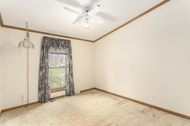 empty room with light carpet, visible vents, baseboards, a ceiling fan, and crown molding