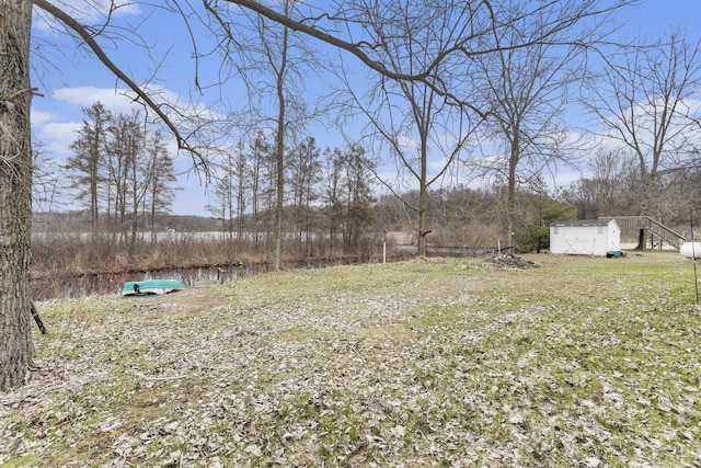 view of yard with a storage unit and an outbuilding