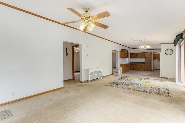 unfurnished living room featuring heating unit, baseboards, light carpet, and ceiling fan with notable chandelier