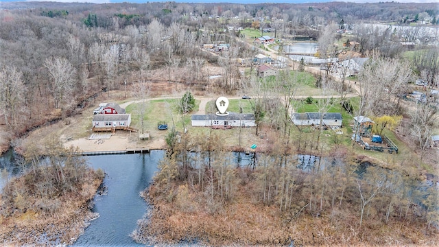 birds eye view of property featuring a view of trees and a water view