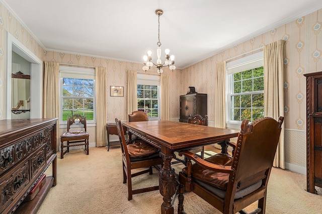 dining area with wallpapered walls, healthy amount of natural light, light colored carpet, a chandelier, and ornamental molding