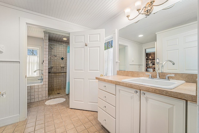bathroom featuring tile patterned flooring, tiled shower, vanity, a chandelier, and recessed lighting