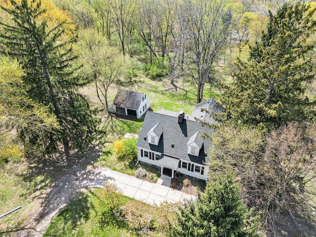 aerial view of property and surrounding area featuring a forest