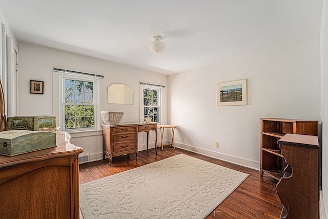 office space with baseboards and dark wood finished floors